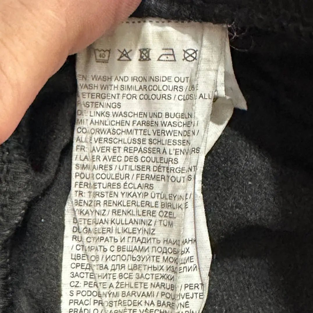 stylish black track pants feature white zipper accents at the ankle