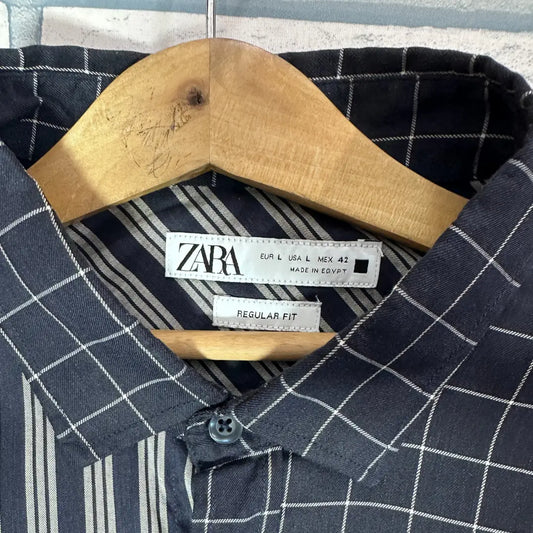 Zara ® It features a bold, deconstructed patchwork design