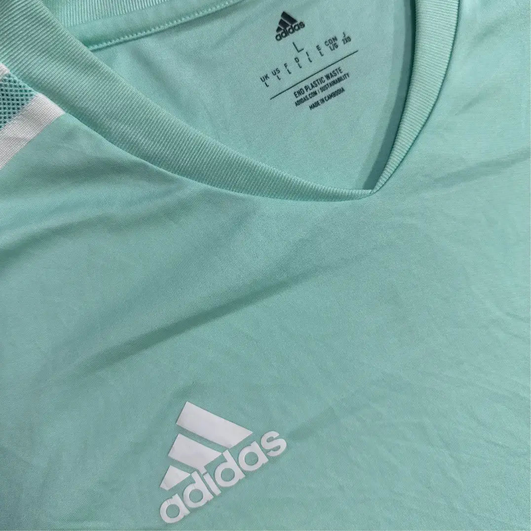 Adidas sports T-shirt in a refreshing mint green with white accents.