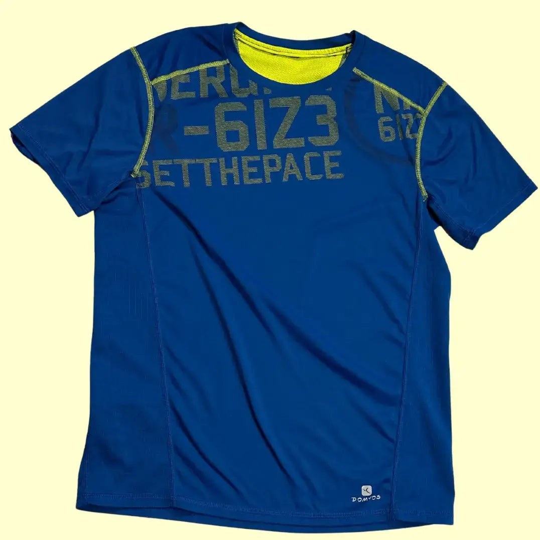 Domyos blue sports t-shirt with neon details and bold front text.