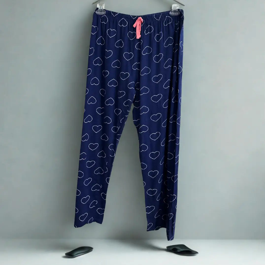 DISNEY® Blue pajama pants with a playful white heart outline pattern all ove