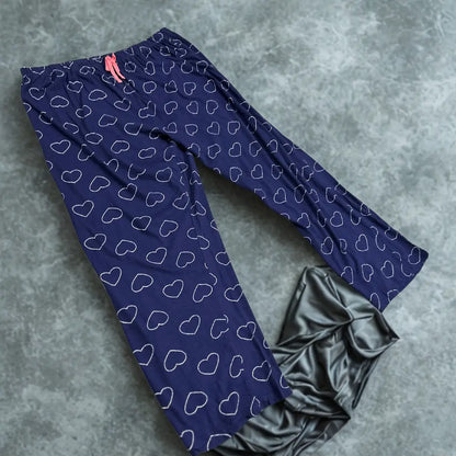 DISNEY® Blue pajama pants with a playful white heart outline pattern all ove