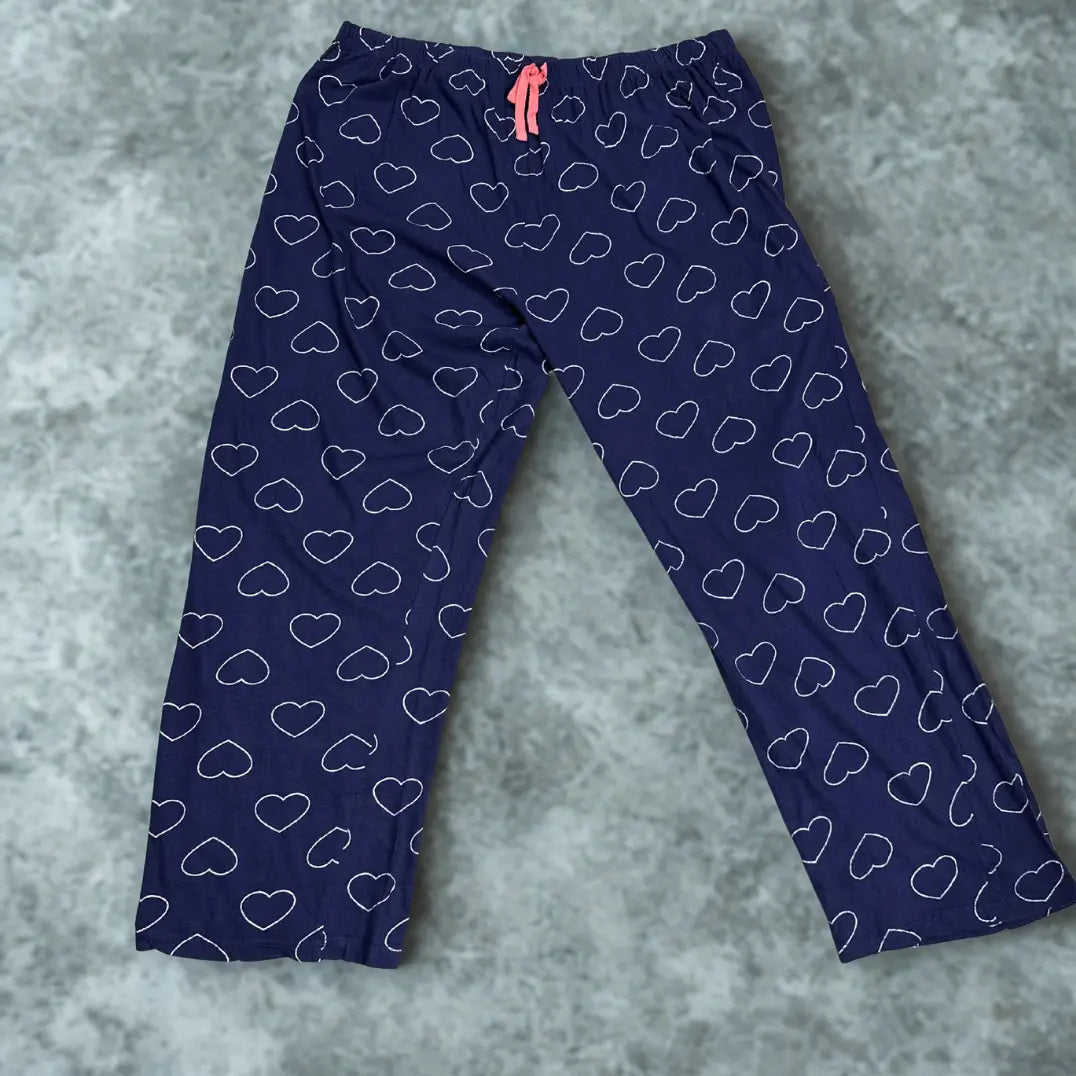 DISNEY® Blue pajama pants with a playful white heart outline pattern all ove