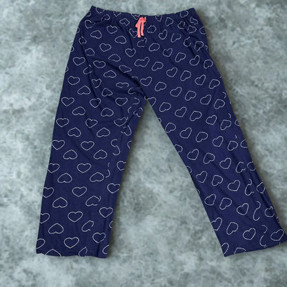 DISNEY® Blue pajama pants with a playful white heart outline pattern all ove