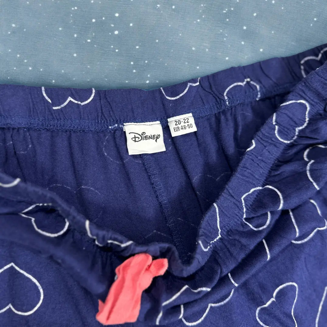 DISNEY® Blue pajama pants with a playful white heart outline pattern all ove