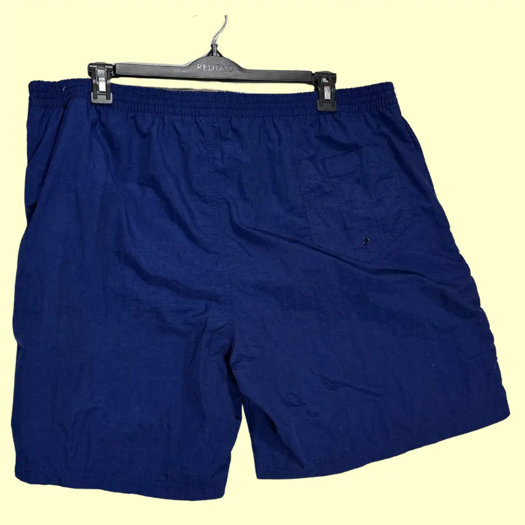 Sand N Sun ®classic swim shorts in solid navy blue with a contrasting yellow elastic waistband and drawstring.