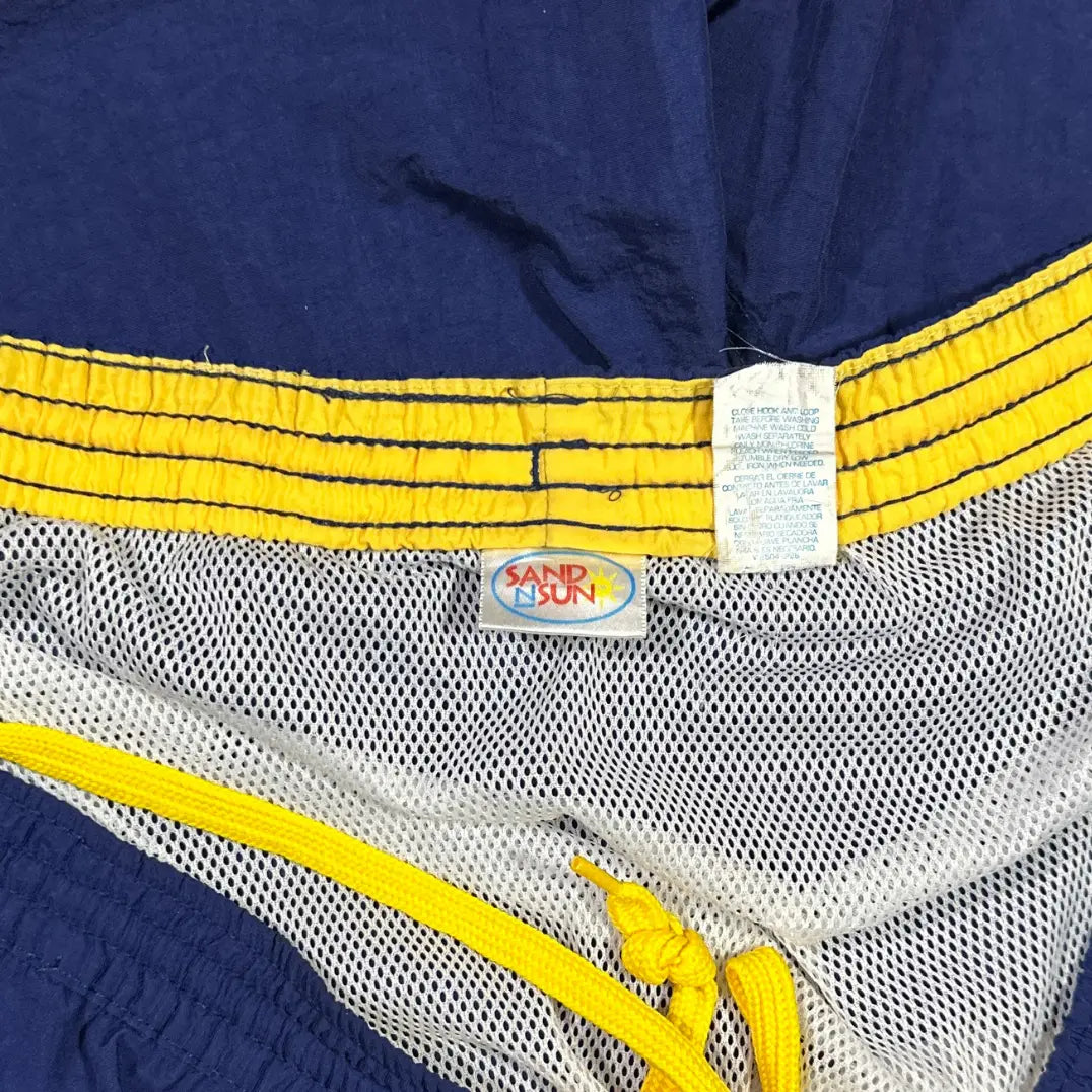 Sand N Sun ®classic swim shorts in solid navy blue with a contrasting yellow elastic waistband and drawstring.
