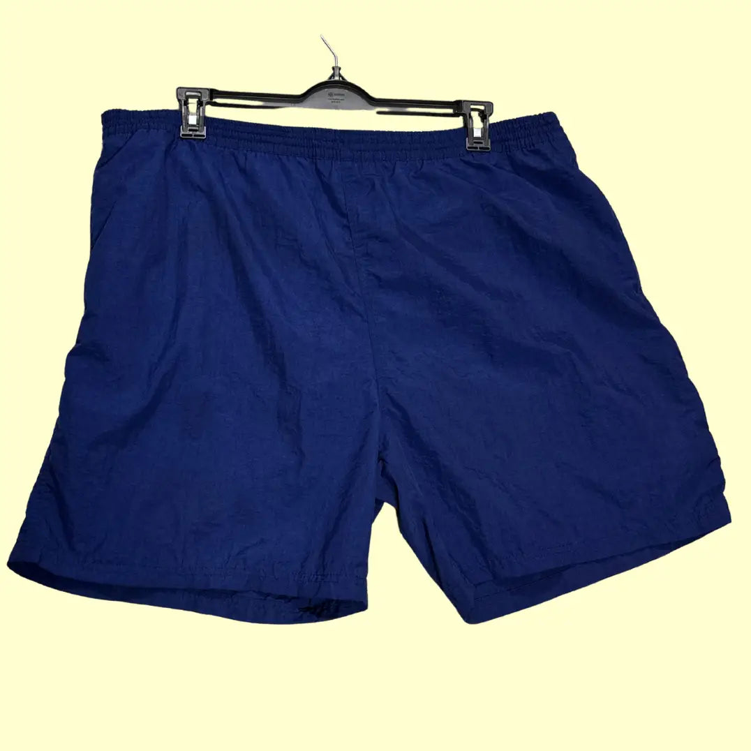Sand N Sun ®classic swim shorts in solid navy blue with a contrasting yellow elastic waistband and drawstring.