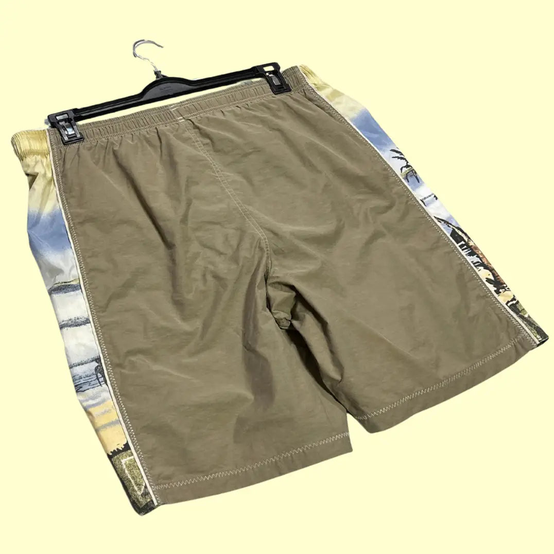 Speedo ®beach-themed swim shorts in olive green with scenic palm tree and ocean print side panels.