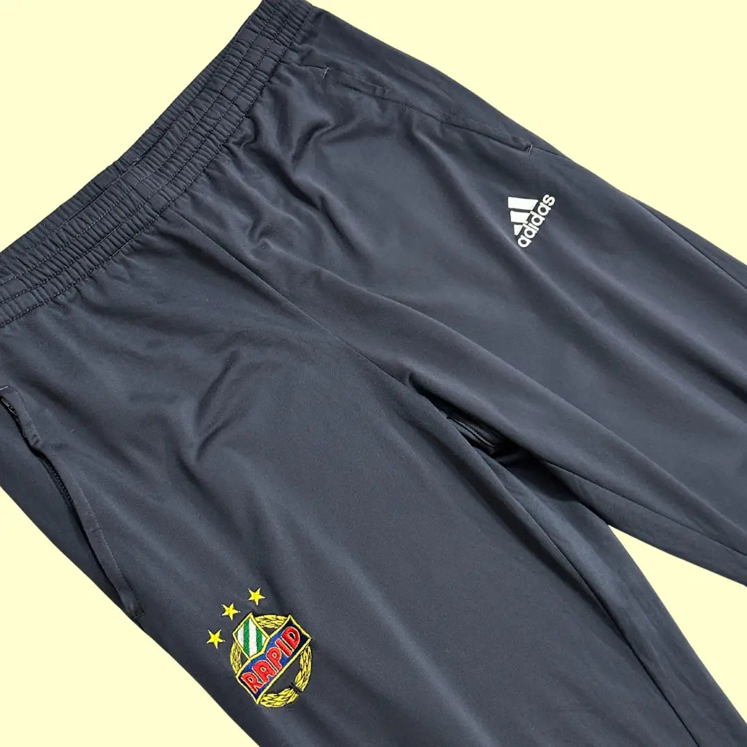 Adidas Rapid Wien Track Pants in dark grey with green side panels.