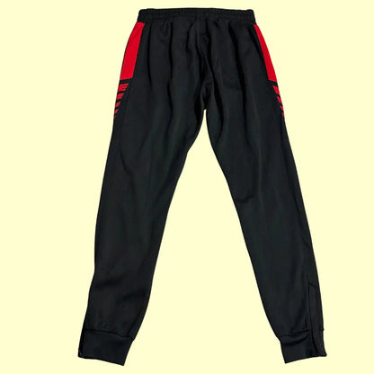 Erima Black Track Pants with striking red side panels and branding.