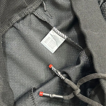 TYPHOON black mesh track pants offer a modern and comfortable design