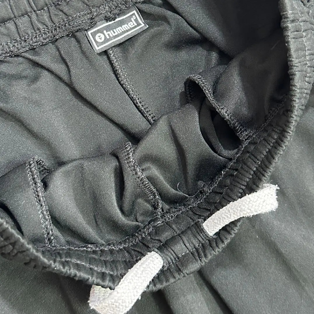 Hummel track pants feature stylish white chevron stripes along the sides