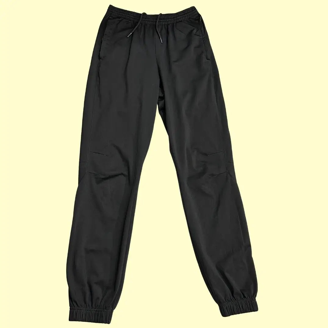 stylish black track pants feature white zipper accents at the ankle