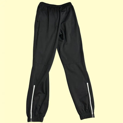 stylish black track pants feature white zipper accents at the ankle