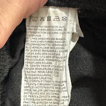 stylish black track pants feature white zipper accents at the ankle