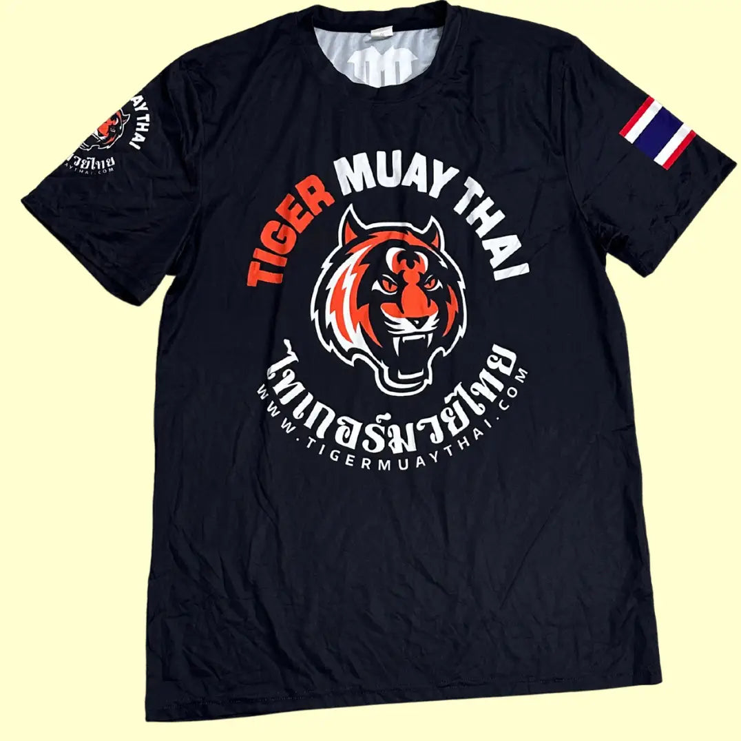 Tiger Muay Thai Training T-shirt in black with bold front tiger logo and Thai script.