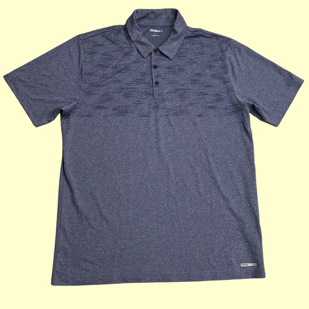OGIO Performance Polo Shirt in dark heather grey with a subtle patterned design across the chest.