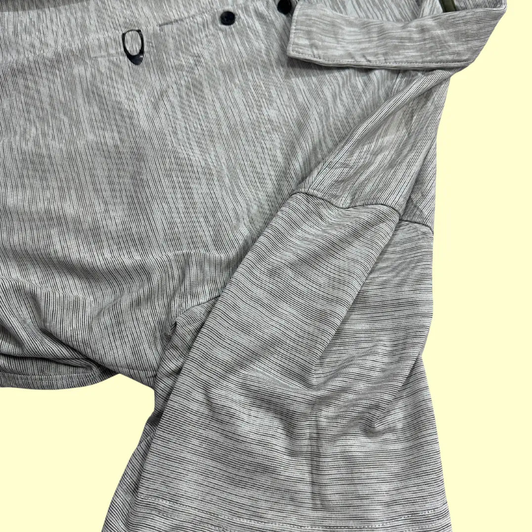 Oakley Performance Polo Shirt in light gray with subtle stripe design.
