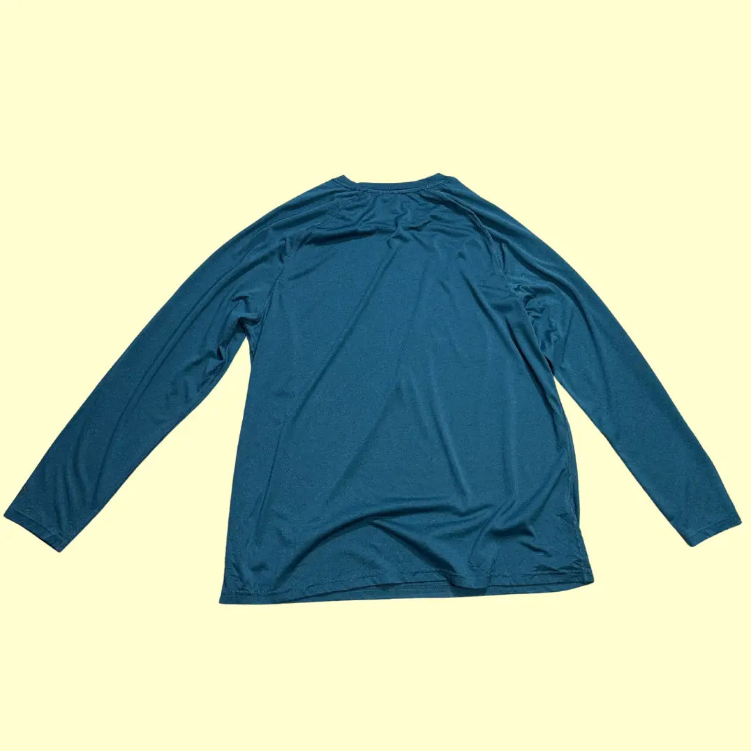 Champion long-sleeve performance shirt in teal blue.