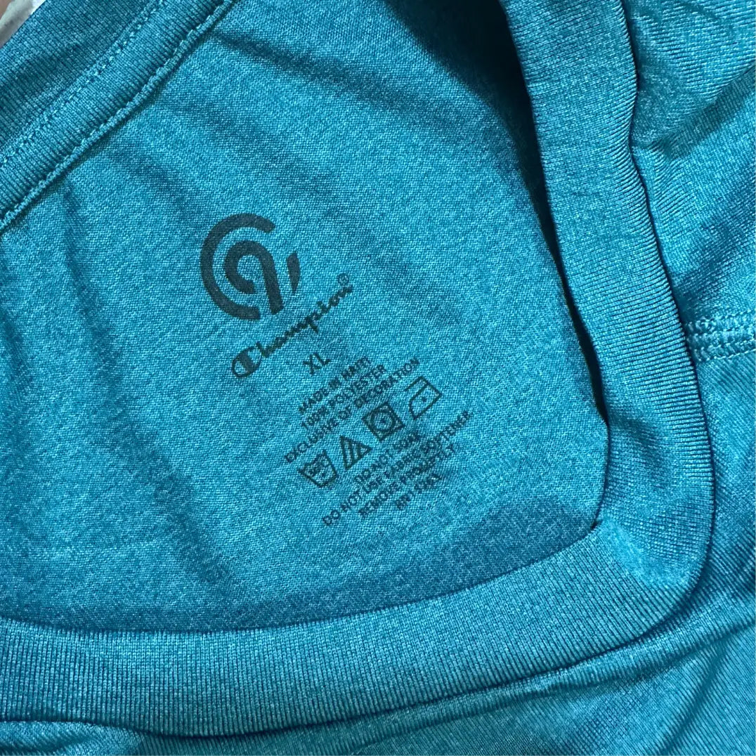 Champion long-sleeve performance shirt in teal blue.
