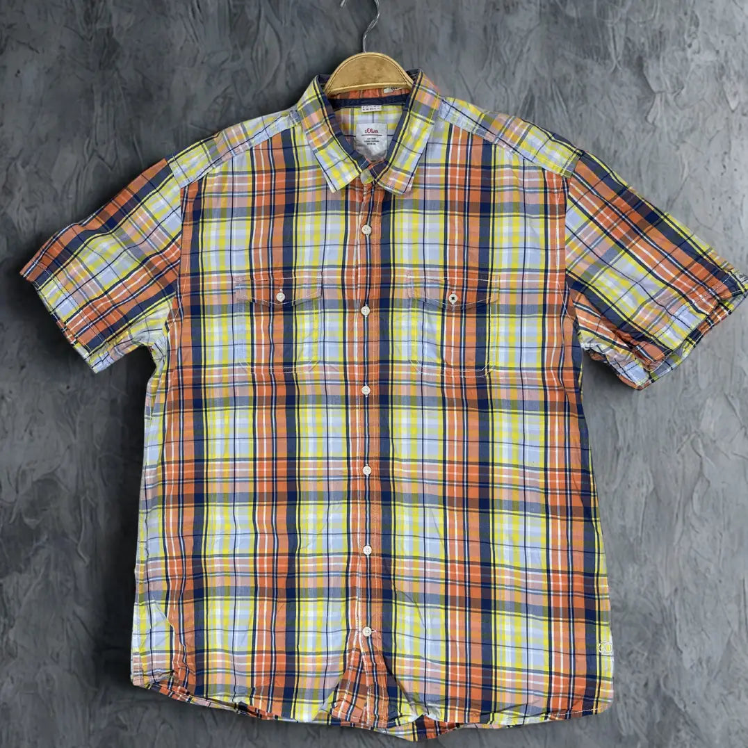 s.Oliver ® It features a bright and cheerful plaid pattern that combines shades of orange, yellow, navy blue, and light blue.