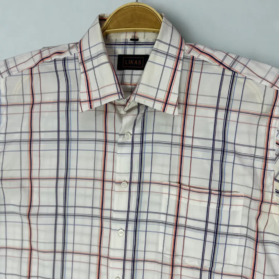 LIKAS ®. It features a clean white background with a sharp, open windowpane plaid pattern.