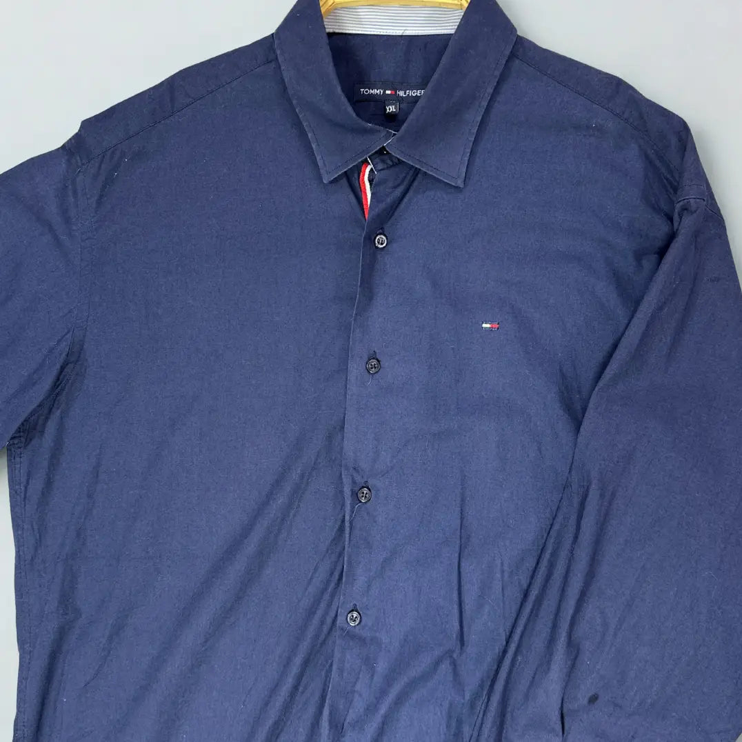 Tommy Hilfiger ®. It comes in a versatile and classic solid navy blue, making it a staple for any wardrobe.