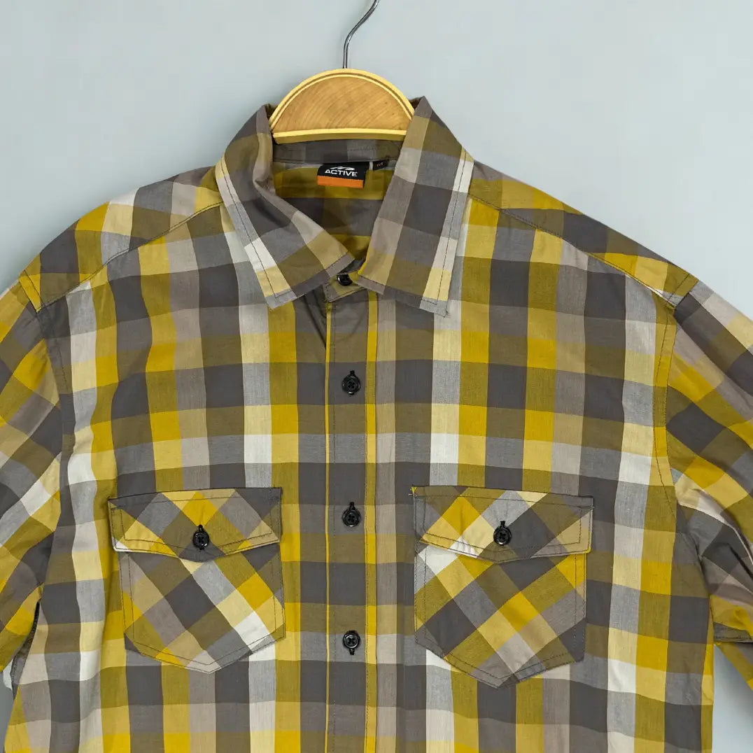 ACTIVE ®. It features a bold and modern plaid pattern in a striking color combination of mustard yellow, grey, and white