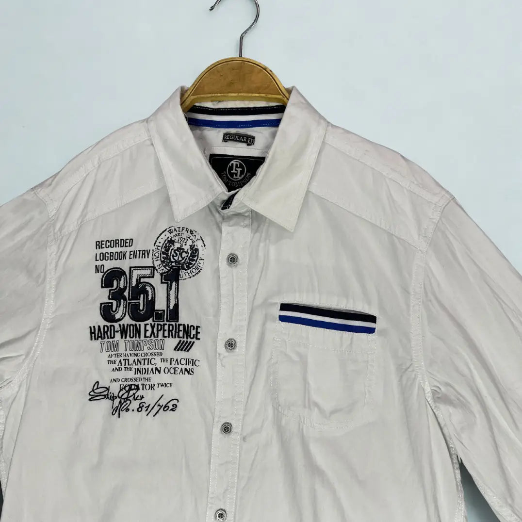 Tom Thompson ®. It comes in a crisp white and is designed to make a statement with its numerous graphic and decorative elements.