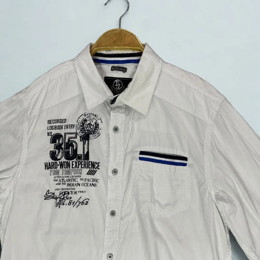 Tom Thompson ®. It comes in a crisp white and is designed to make a statement with its numerous graphic and decorative elements.