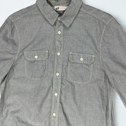 H & M ®. It comes in a solid grey chambray or end-on-end fabric, giving it a textured yet soft feel.