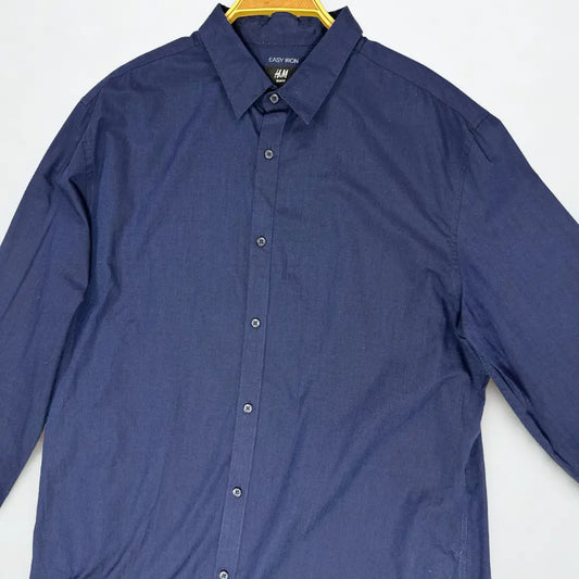 H&M ®. It comes in a deep, versatile solid navy blue, making it a perfect staple for any modern wardrobe.